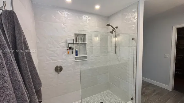 a spacious bathroom with a double vanity sink and mirror