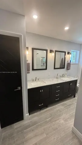 a spacious bathroom with a double vanity sink and mirror