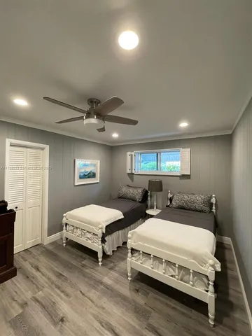 a spacious bedroom with two beds and a window