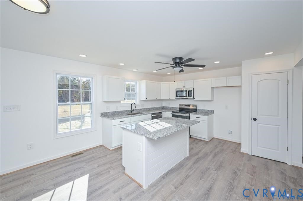 Lot 276 Norway Road Ruther Glen, VA 22546 - Photo 8 of 36 a kitchen with white cabinets and appliances