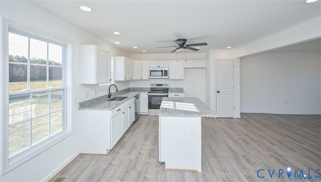 Lot 276 Norway Road Ruther Glen, VA 22546 - Photo 9 of 36 a kitchen that has a lot of white cabinets and wooden floor