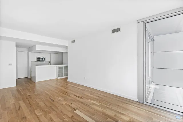 a kitchen with white cabinets and white appliances
