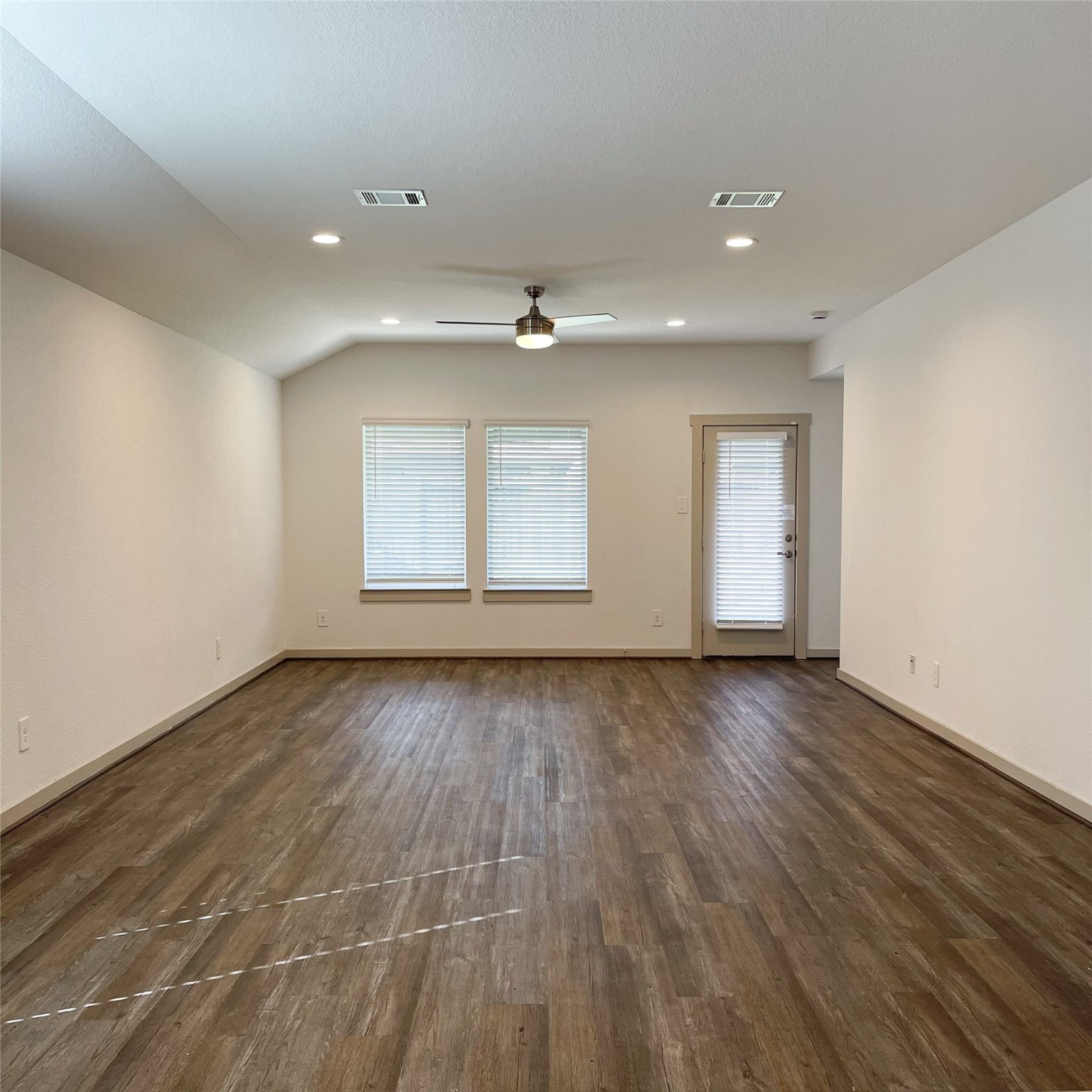 6814 Bradford Terrace Road Richmond, TX 77407 - Photo 16 of 31 an empty room with wooden floor and windows