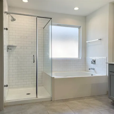 a bathroom with a bathtub and a shower