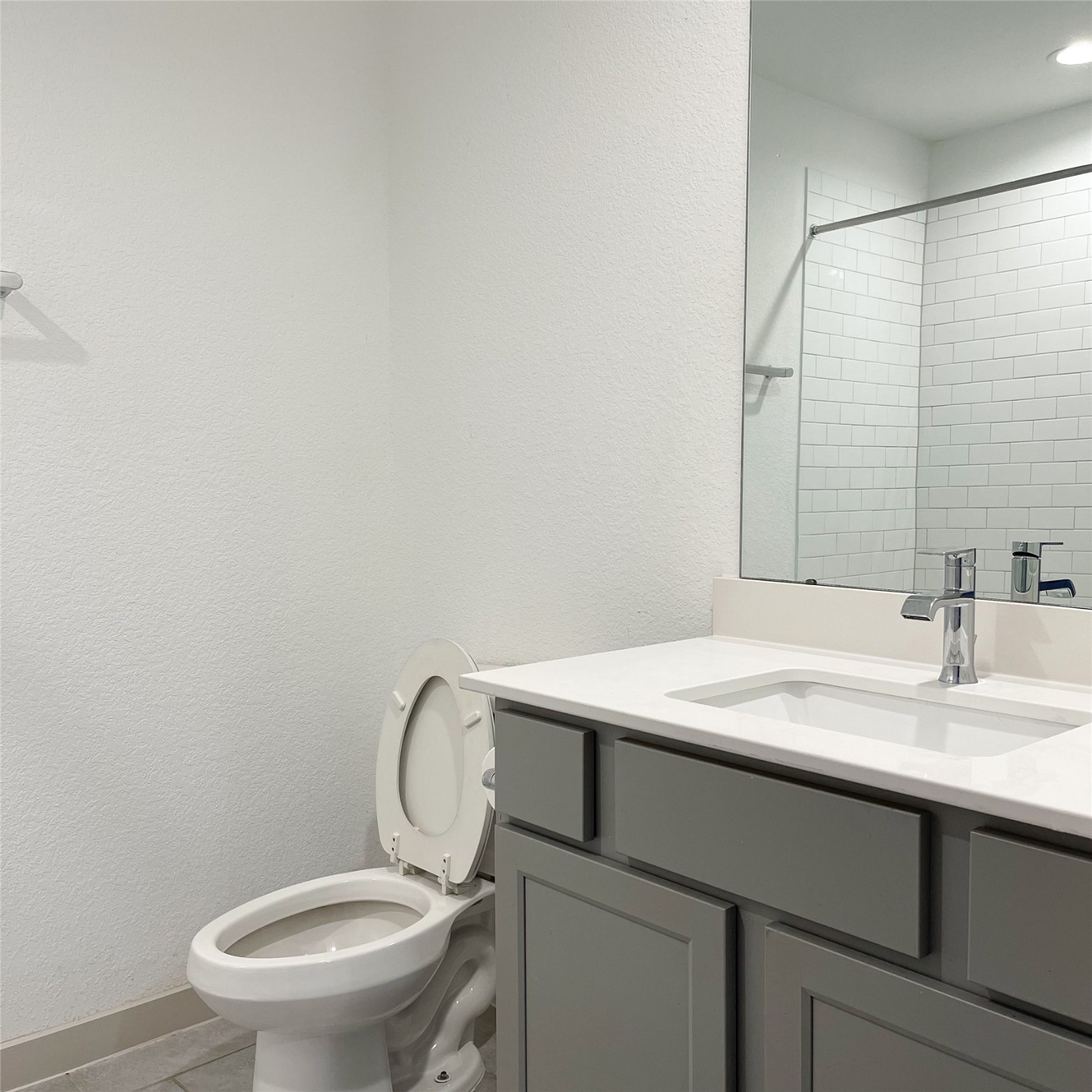 6814 Bradford Terrace Road Richmond, TX 77407 - Photo 4 of 31 a bathroom with a granite countertop toilet sink and mirror