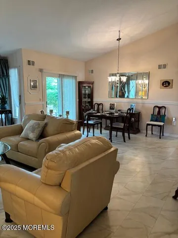 a living room with furniture a window and a table