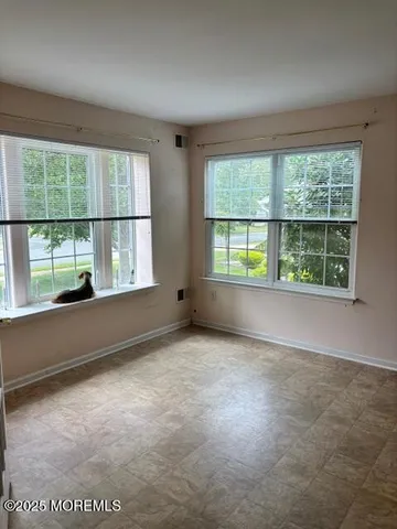 an empty room with large windows
