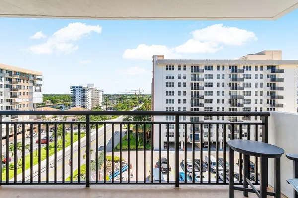 a city view from a balcony with outdoor seating