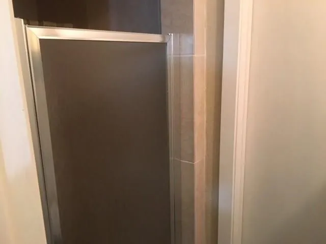 a bathroom with a glass shower door