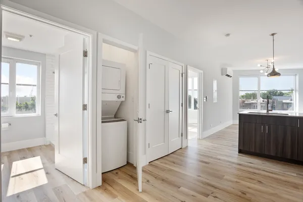 a view of a kitchen from the hallway with a window