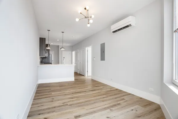 a view of a kitchen with wooden floor and a ceiling fan