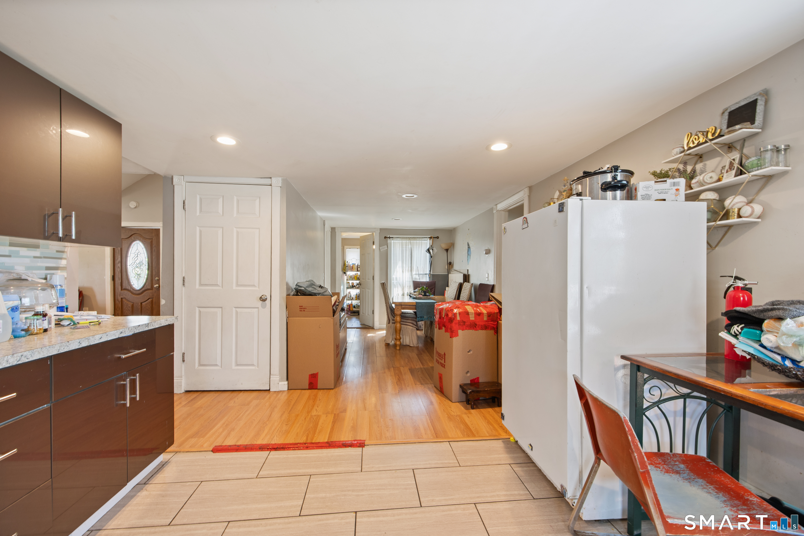 277 South Main Street Torrington, CT 06790 - Photo 19 of 26 a view of a kitchen with refrigerator and dining table