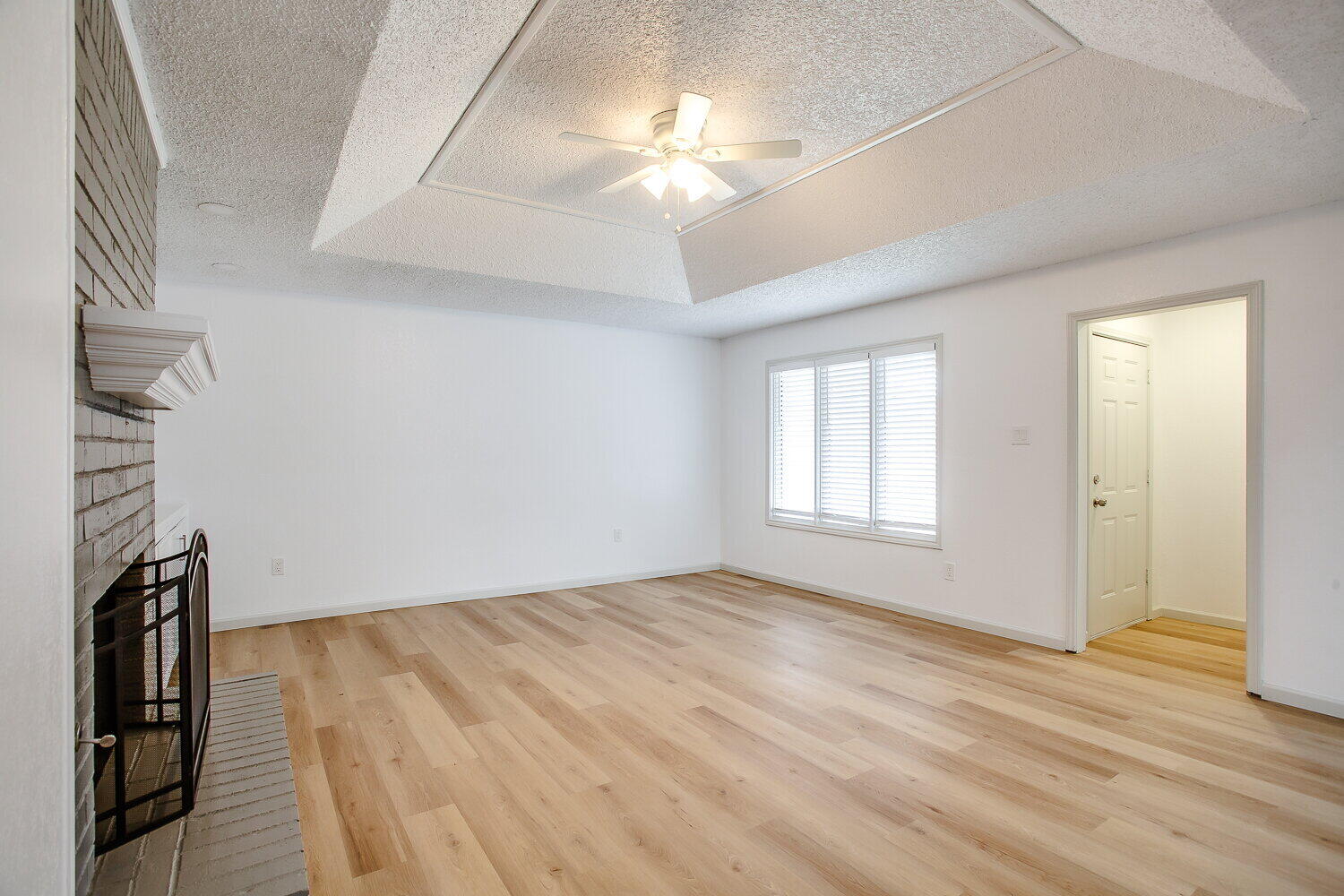 4804 76th Street, Unit A Lubbock, TX 79424 - Photo 12 of 31 a view of empty room with wooden floor and fan
