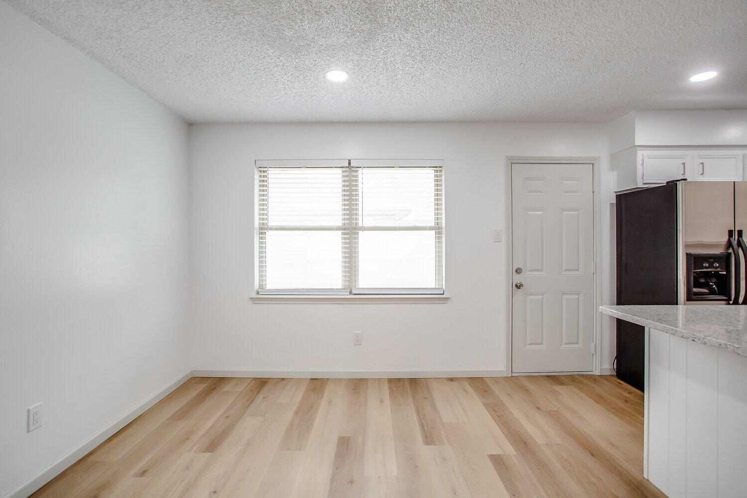 4804 76th Street, Unit A Lubbock, TX 79424 - Photo 16 of 31 an empty room with a window and a refrigerator