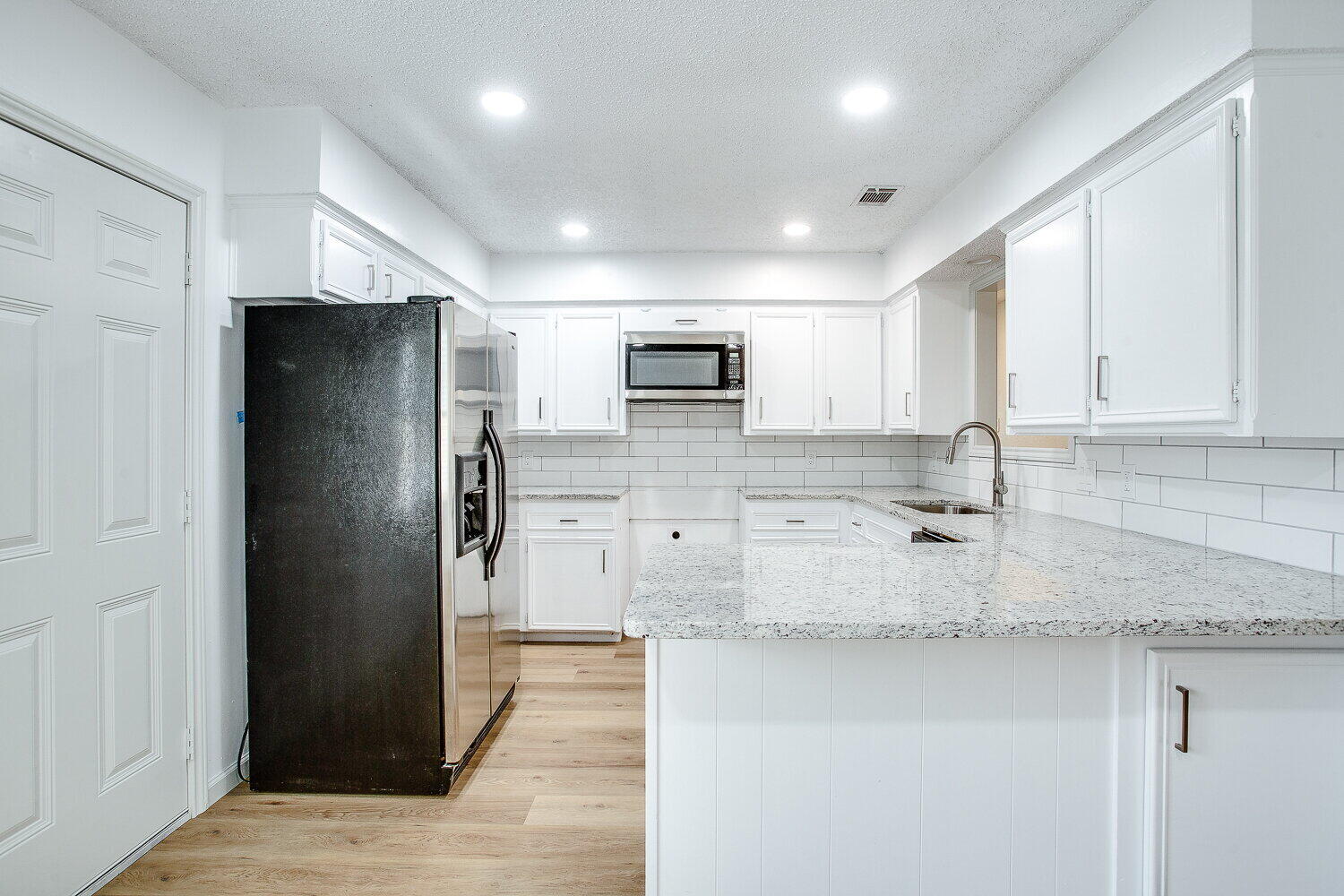 4804 76th Street, Unit A Lubbock, TX 79424 - Photo 17 of 31 a kitchen with stainless steel appliances granite countertop a refrigerator and a sink