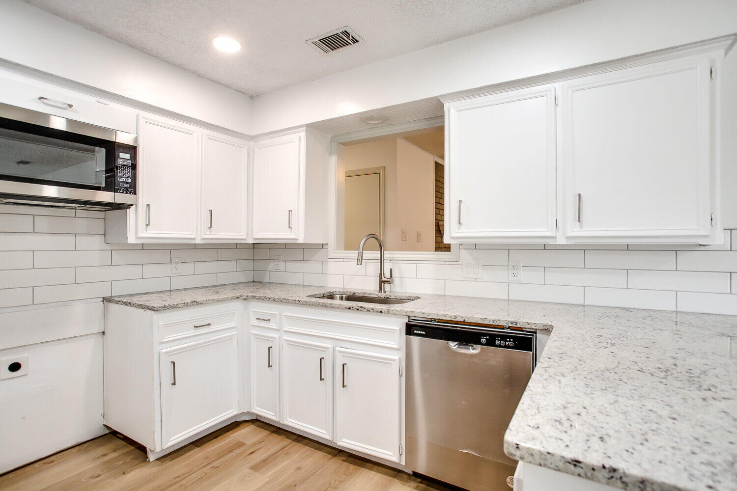 4804 76th Street, Unit A Lubbock, TX 79424 - Photo 18 of 31 a kitchen with white cabinets appliances and sink