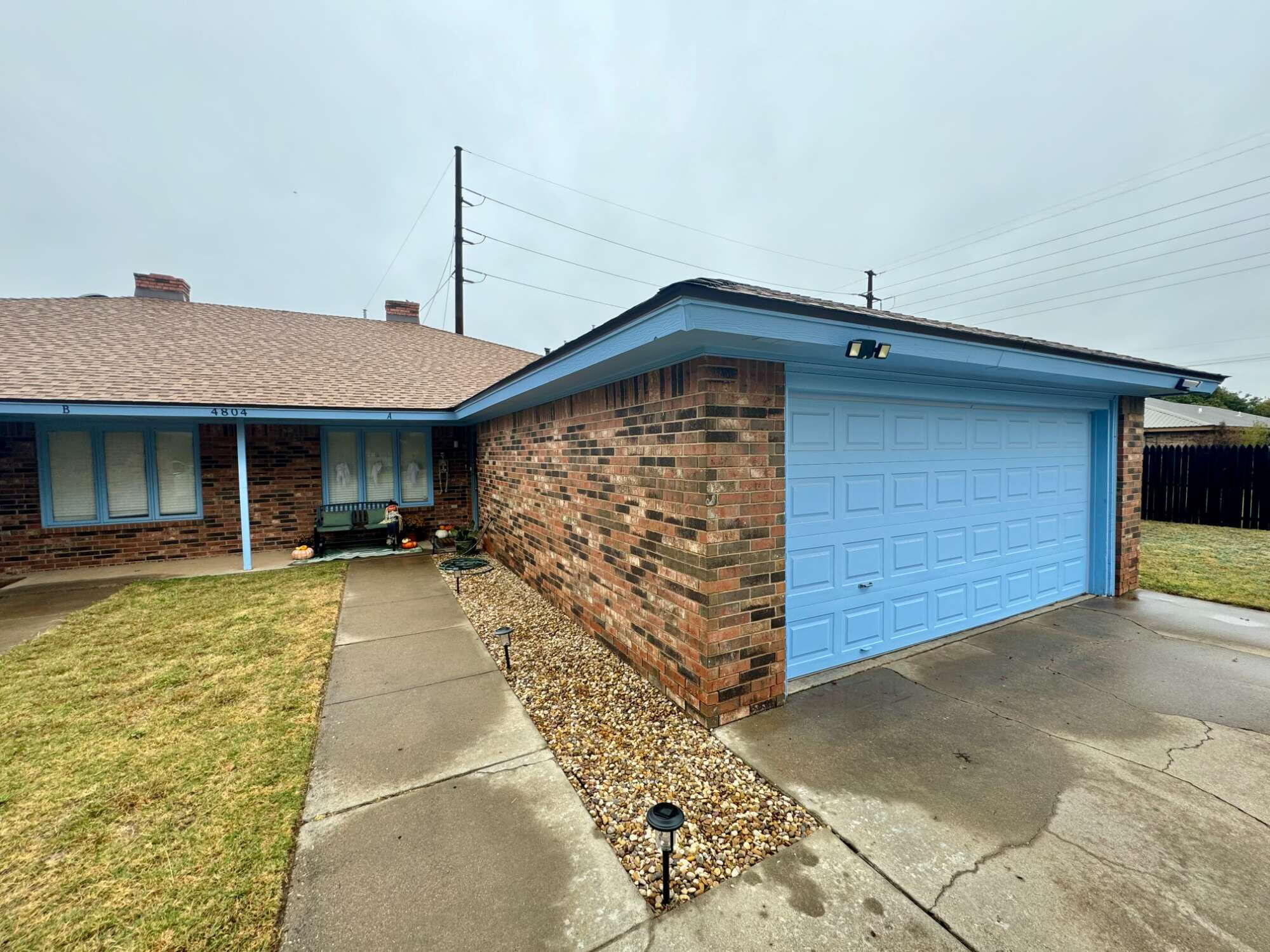 4804 76th Street, Unit A Lubbock, TX 79424 - Photo 2 of 31 a front view of a house with a yard