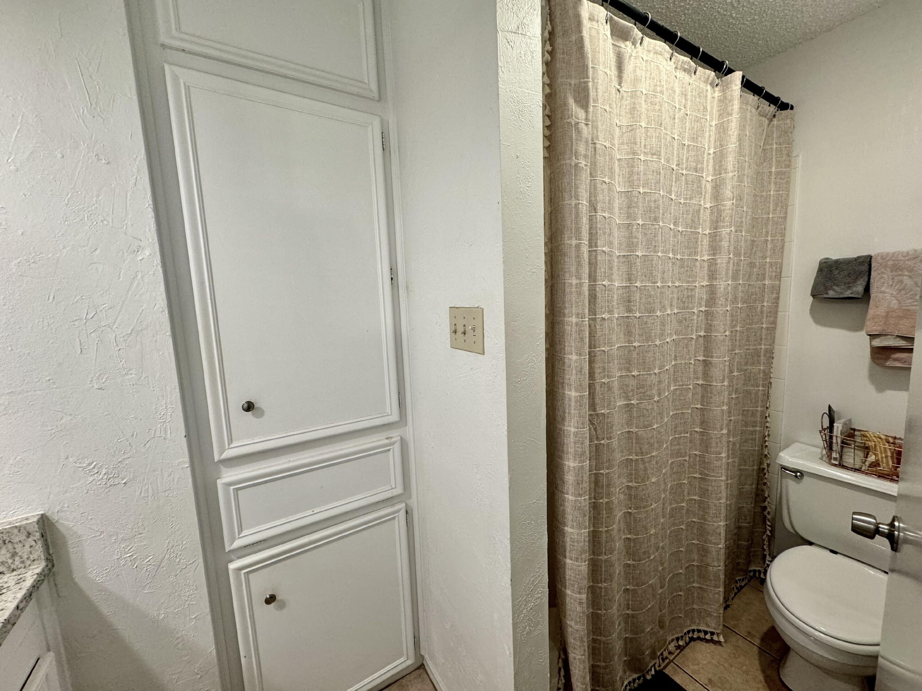 4804 76th Street, Unit A Lubbock, TX 79424 - Photo 26 of 31 a bathroom with a shower and a toilet