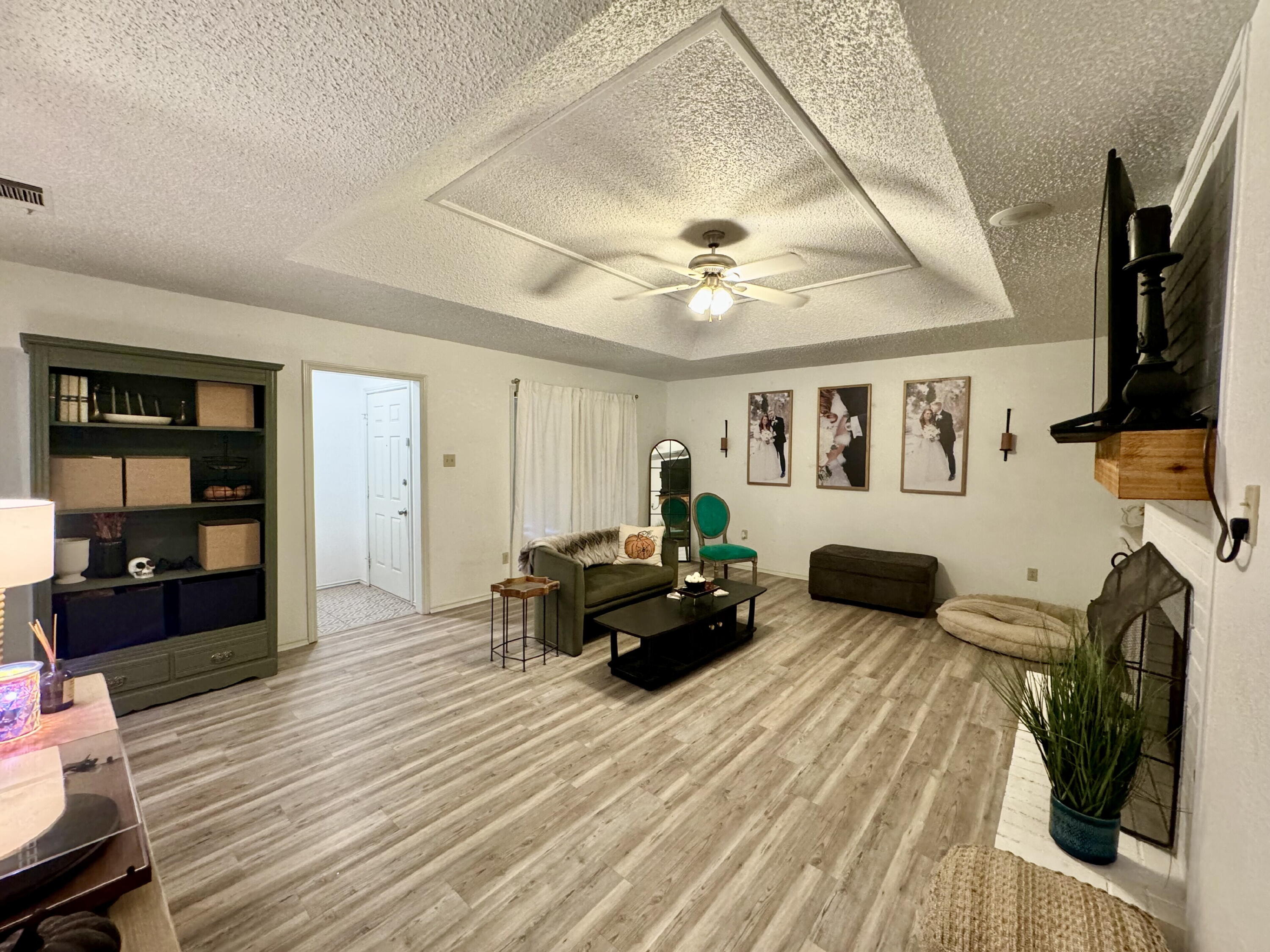 4804 76th Street, Unit A Lubbock, TX 79424 - Photo 5 of 31 a living room with furniture and a flat screen tv