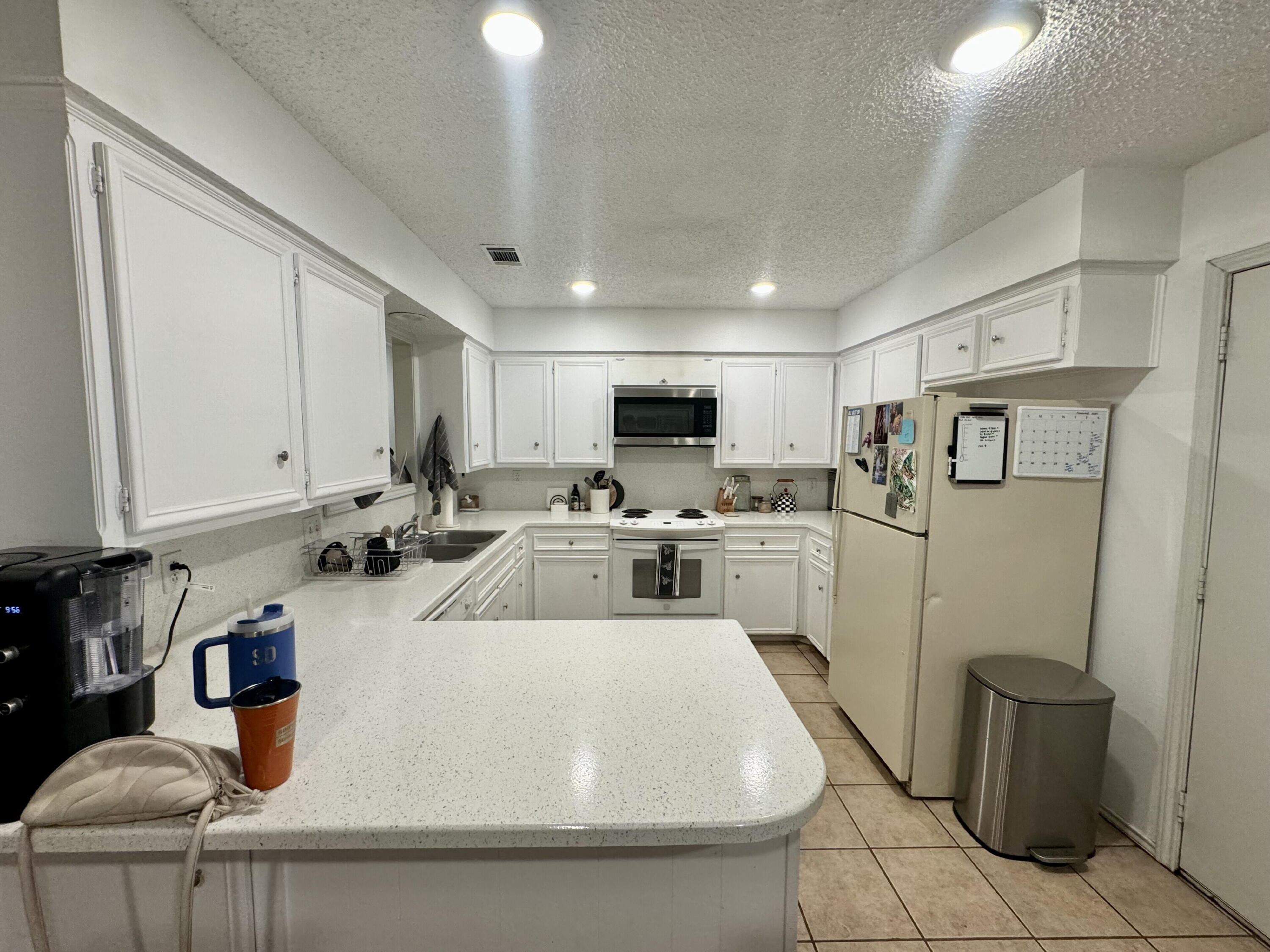 4804 76th Street, Unit A Lubbock, TX 79424 - Photo 6 of 31 a view of a kitchen with sink cabinets and appliances