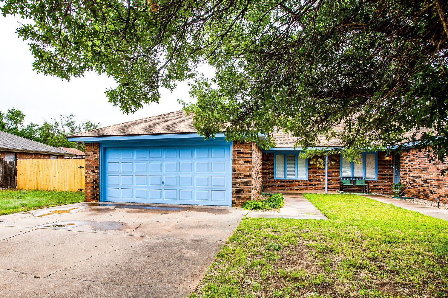 4804 76th Street, Unit A Lubbock, TX 79424 - Photo 9 of 31 a front view of a house with a yard and garage