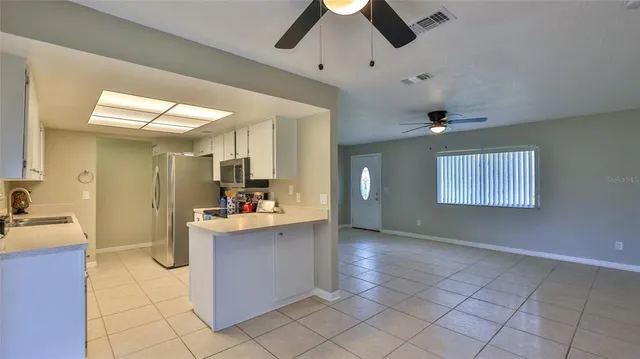 a kitchen with a stove a sink and a refrigerator