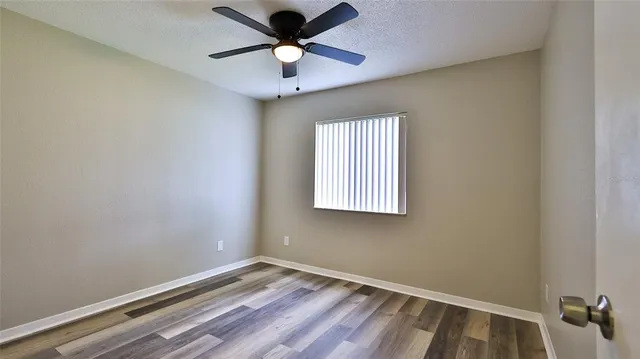 an empty room with wooden floor and closet
