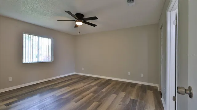 wooden floor in an empty room with a window