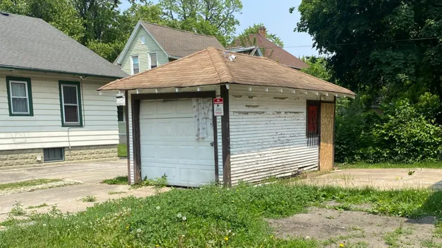 a small white house with a white roof and front of house