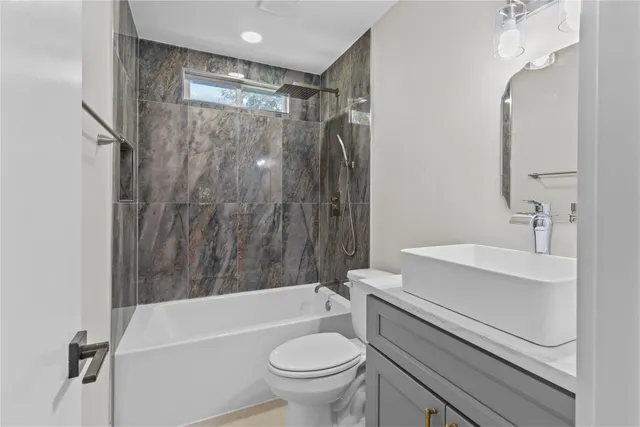 a bathroom with a sink a toilet and a bathtub