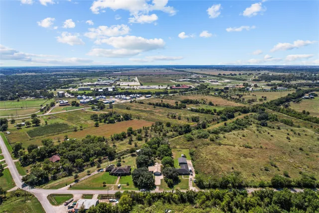 an aerial view of residential building and trees around