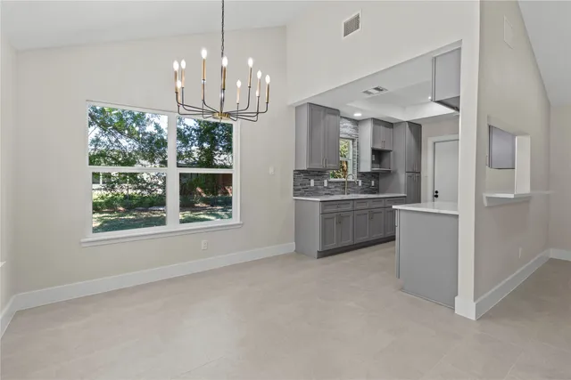a kitchen with stainless steel appliances granite countertop a stove and a refrigerator