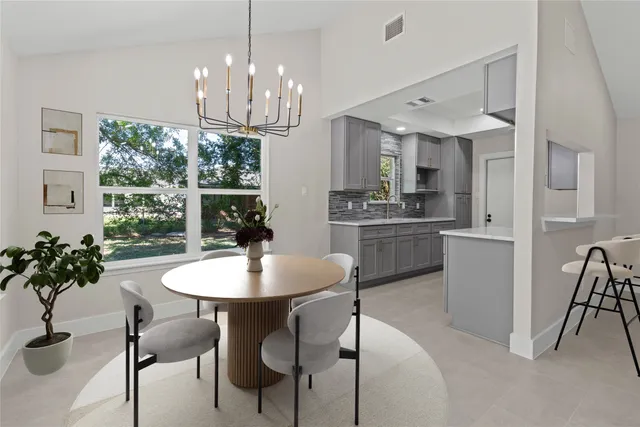 a kitchen with a table and chairs in it