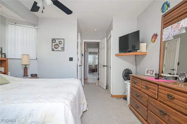 a bedroom with a bed and a flat tv screen