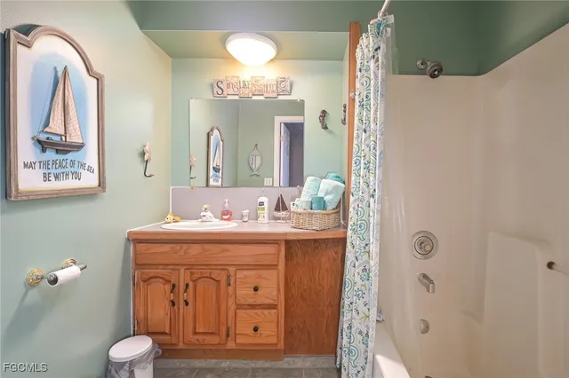 a bathroom with a granite countertop sink a toilet and a mirror