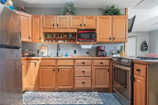 a kitchen with stainless steel appliances granite countertop a refrigerator sink and cabinets