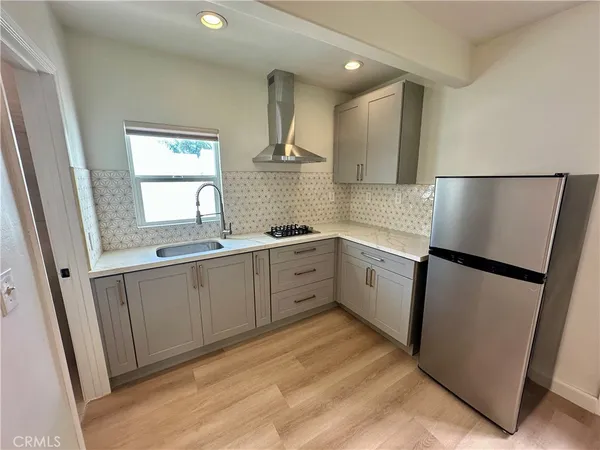 a kitchen with white cabinets and white appliances