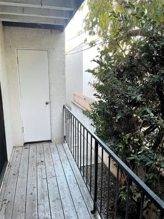 a view of balcony with wooden floor