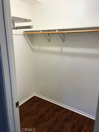 a bathroom with a granite countertop toilet sink and mirror