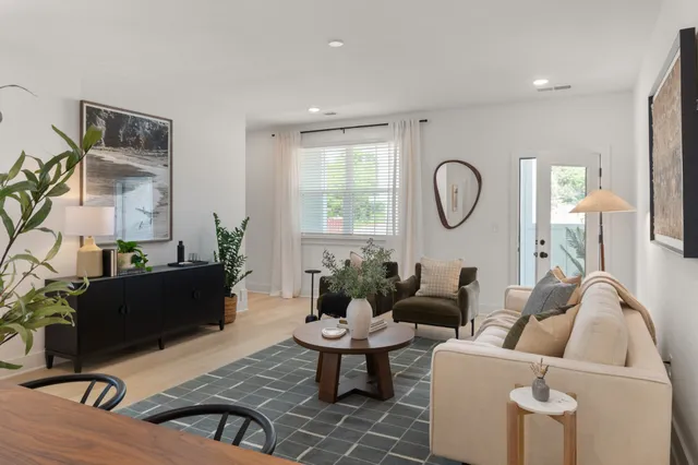 a living room with furniture and wooden floor