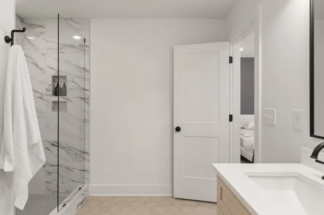 a bathroom with a sink a toilet and shower