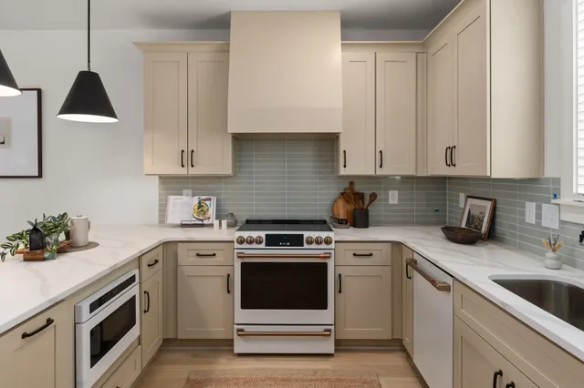 a kitchen with white cabinets and white appliances