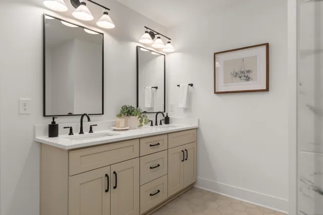 a bathroom with a double vanity sink and a mirror