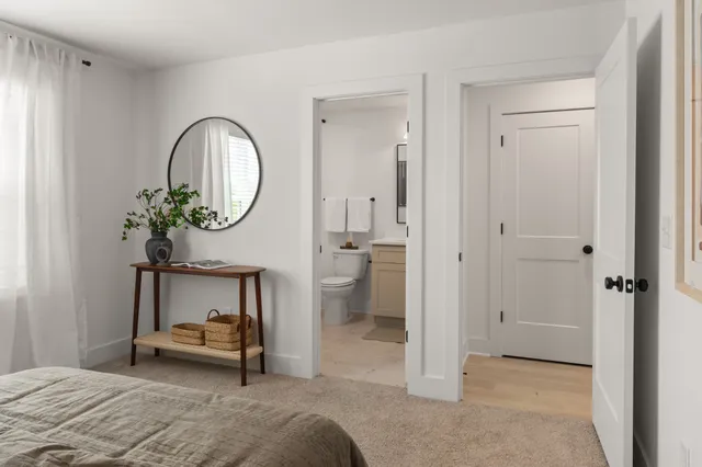 a bedroom with a bed and a mirror