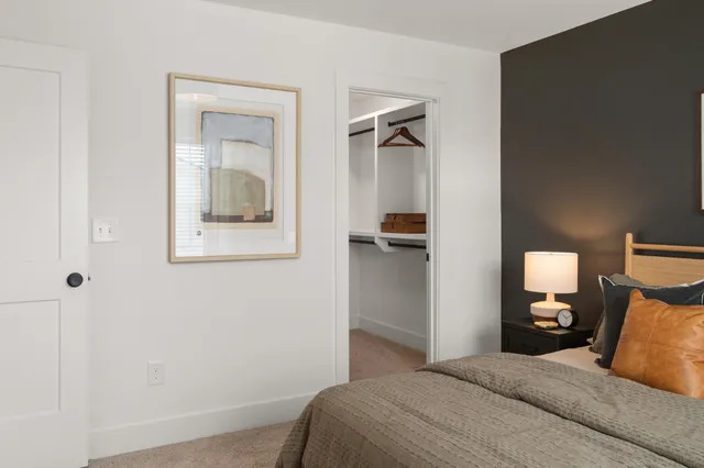 a bedroom with a bed and a mirror