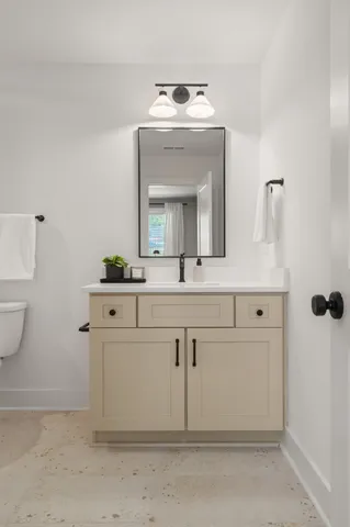 a bathroom with a sink vanity and mirror