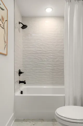 a bathroom with a bathtub and a toilet