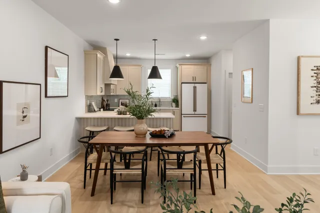 a view of a dining room with furniture and wooden floor