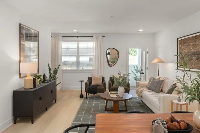 a living room with furniture a rug and a window