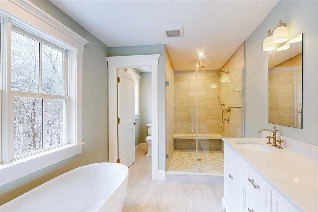 298 Summer Street Westwood, MA 02090 - Photo 11 of 24 a bathroom with a granite countertop sink a shower and a mirror